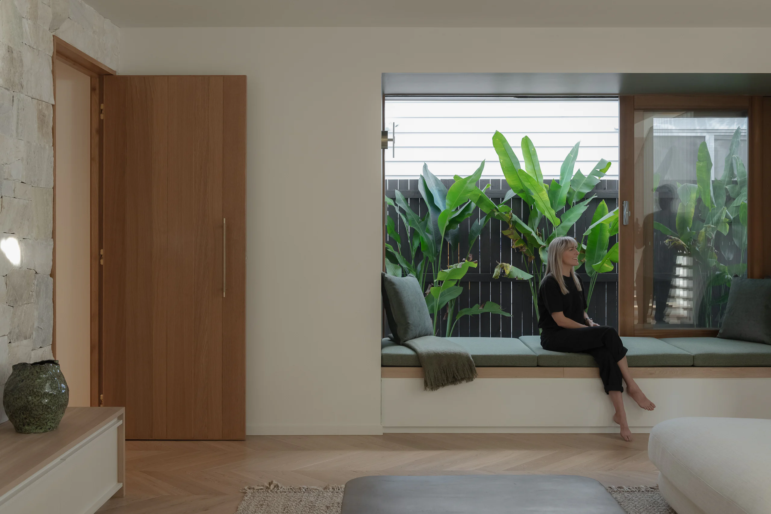 Living room window seat looking onto a planted courtyard, Grange Haus